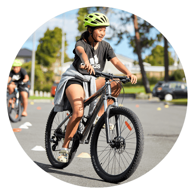 A girl cycling and turning.